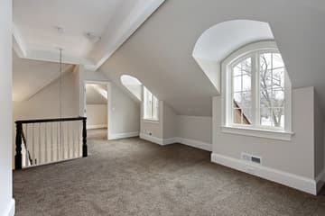 A bright empty carpeted upper floor prepared for a home sale.