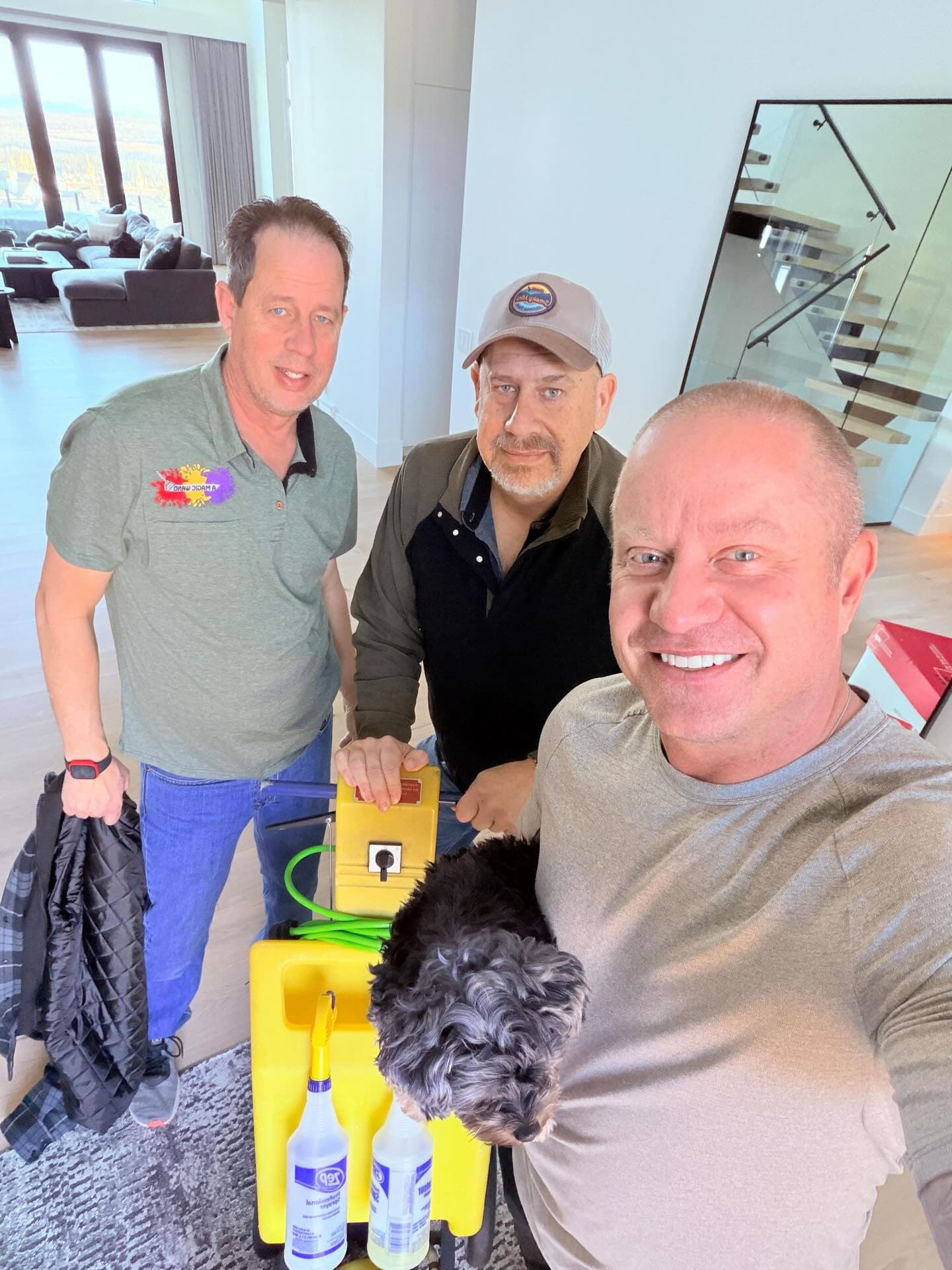 Justin Havre with the A Magic Wand team and carpet-cleaning equipment in a Calgary home.